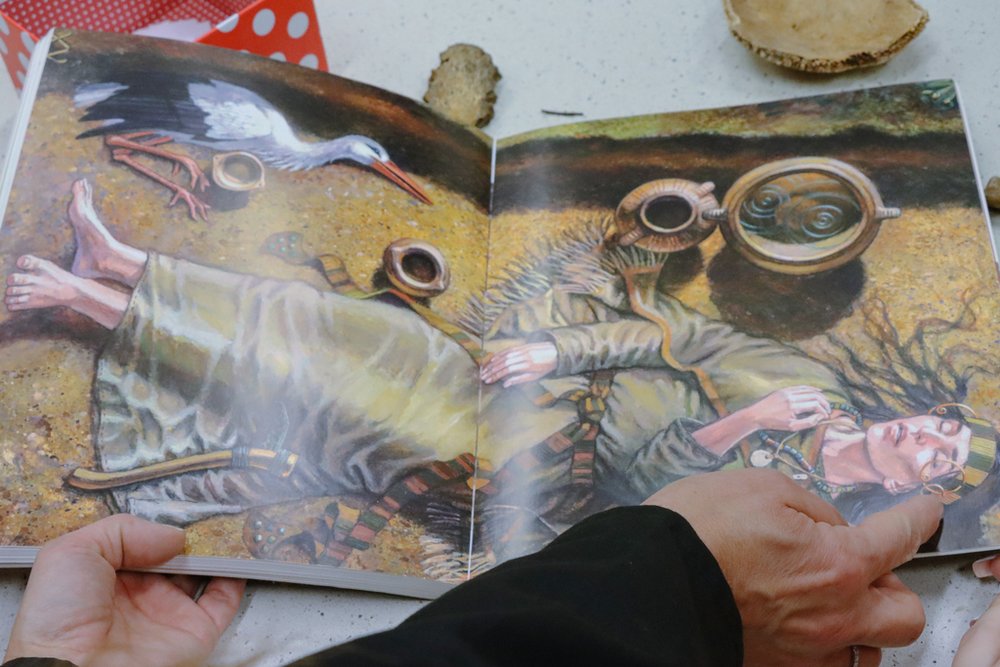 książka z ilustracją rekonstrukcji starożytnego pochówku